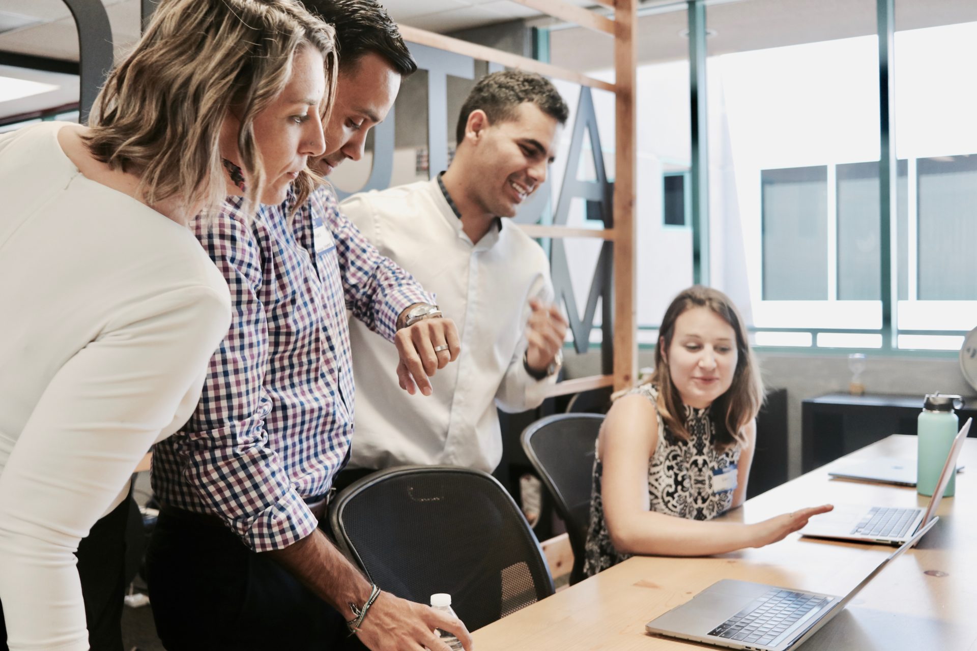 group of paralegals looking at laptops in a meeting