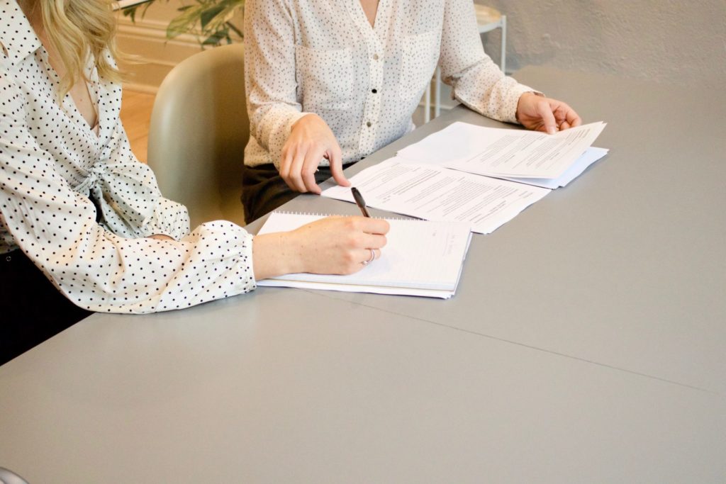 image of two women paralegals looking at legal documents