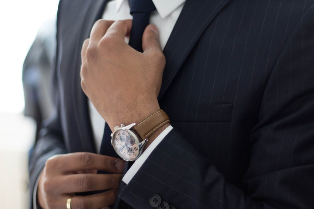 paralegal getting ready, wearing a suit and tie